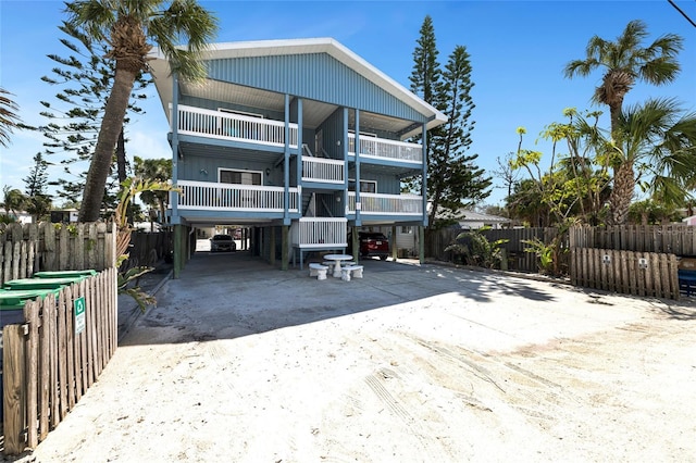 812 Gulf # 3, Indian Rocks Beach, FL 33785 - rear view of house with driveway, a carport, and fence