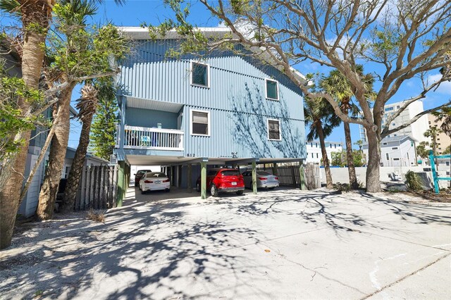812 Gulf # 3, Indian Rocks Beach, FL 33785 - coastal inspired home with driveway, a carport, and fence