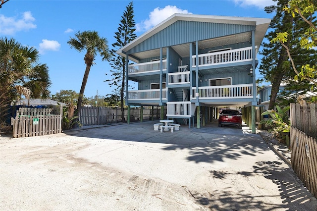 812 Gulf # 3, Indian Rocks Beach, FL 33785 - view of front of home featuring driveway, a carport, and fence