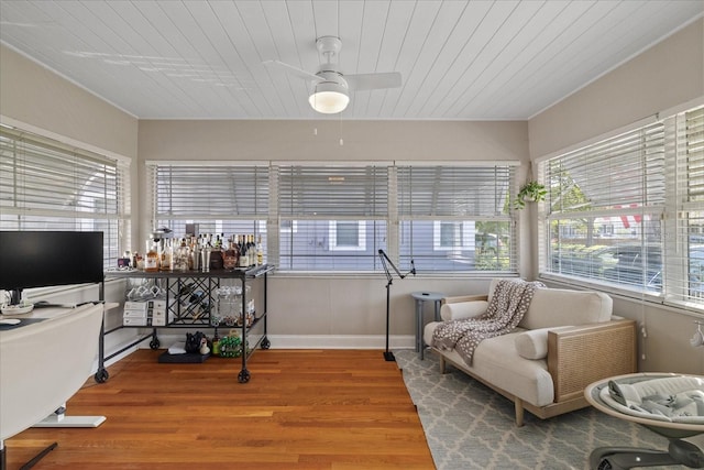 interior space featuring a ceiling fan, wooden ceiling, and wood finished floors