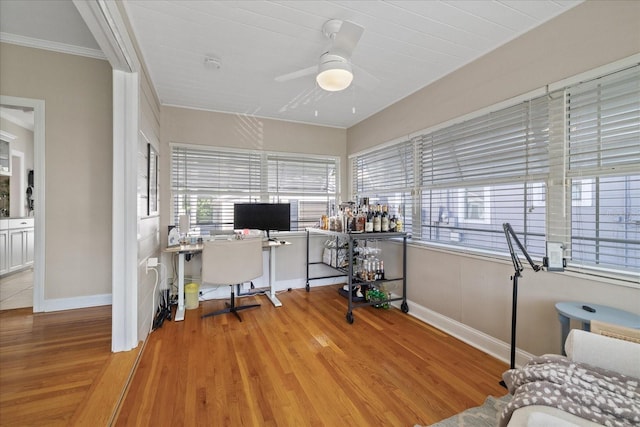 office area with baseboards, wood finished floors, and a ceiling fan