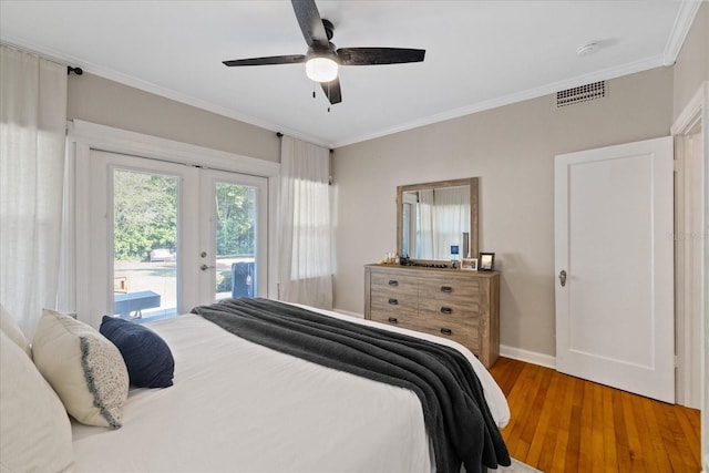 bedroom featuring french doors, ornamental molding, access to exterior, visible vents, and wood finished floors