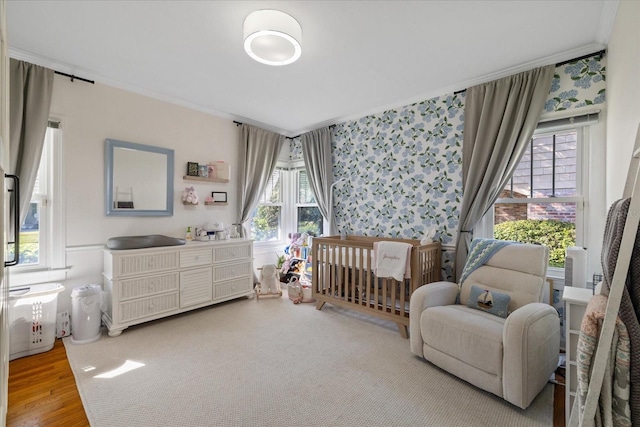 bedroom featuring light wood-type flooring and ornamental molding