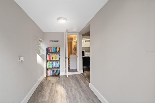 hall with baseboards, wood finished floors, and french doors