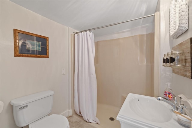 bathroom with curtained shower, toilet, and a sink