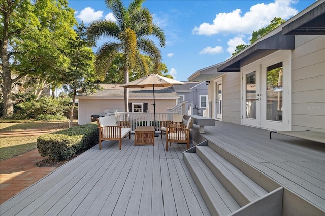 wooden terrace featuring an outdoor living space and french doors
