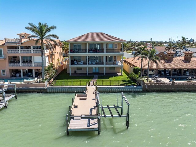 700 126th Ave, Treasure Island, FL 33706 - view of dock with a water view, fence, boat lift, a residential view, and a lawn