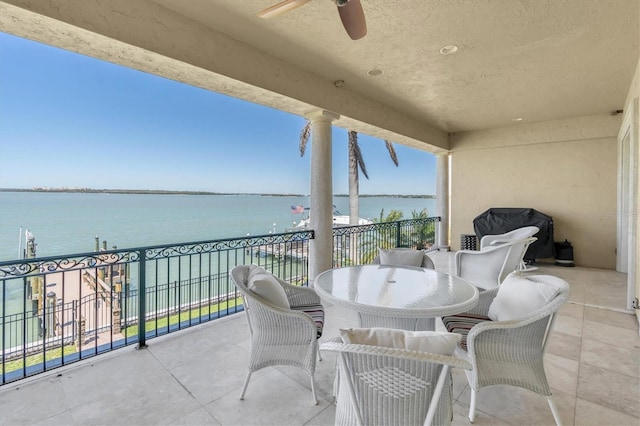 700 126th Ave, Treasure Island, FL 33706 - balcony with a water view, ceiling fan, and outdoor dining area