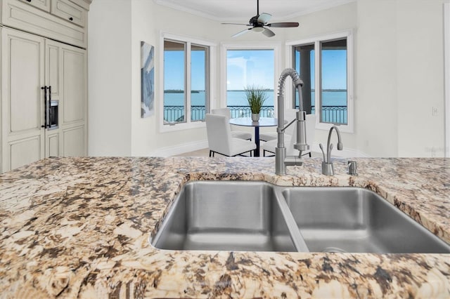 700 126th Ave, Treasure Island, FL 33706 - details featuring ceiling fan, a sink, crown molding, and light stone counters