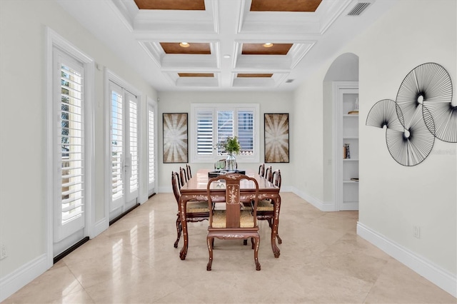 700 126th Ave, Treasure Island, FL 33706 - dining area with coffered ceiling, built in features, baseboards, visible vents, and arched walkways