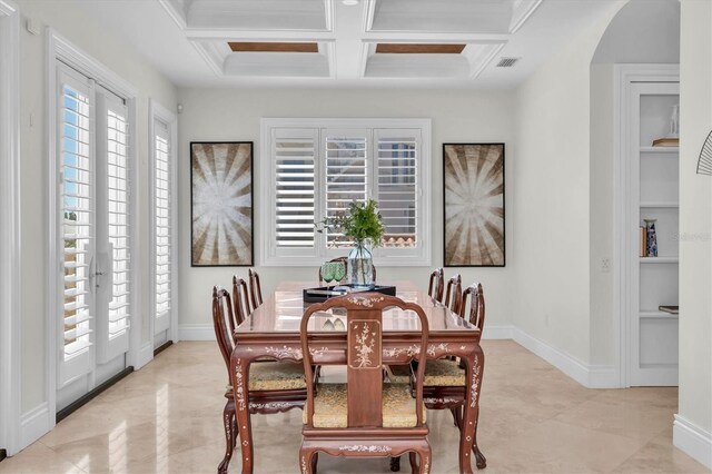 700 126th Ave, Treasure Island, FL 33706 - dining space featuring arched walkways, baseboards, coffered ceiling, and beam ceiling