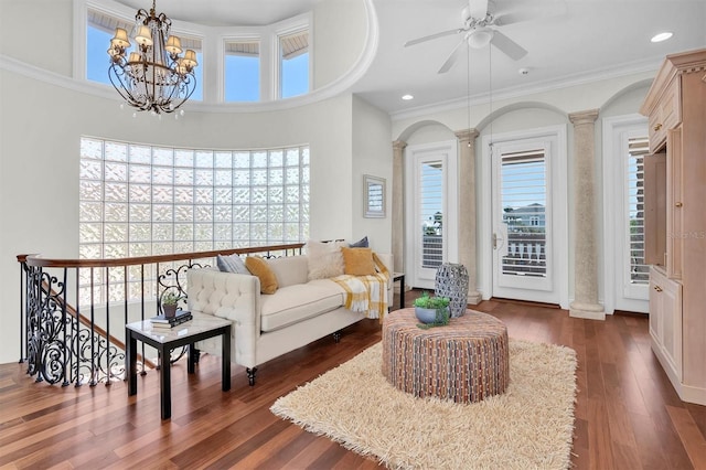 700 126th Ave, Treasure Island, FL 33706 - living room featuring ceiling fan with notable chandelier, ornate columns, ornamental molding, recessed lighting, and dark wood-style flooring