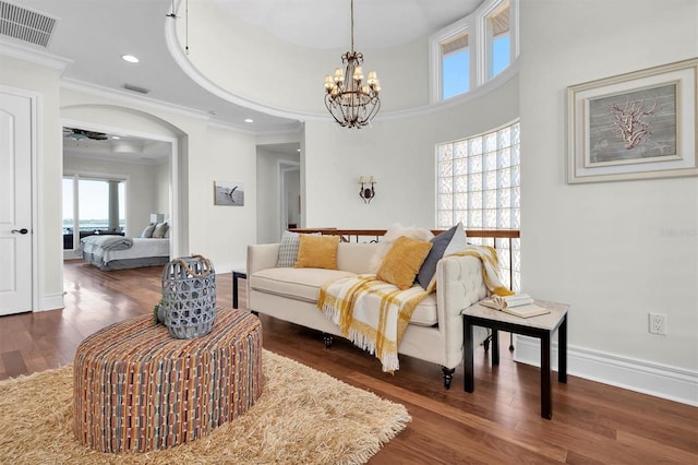 700 126th Ave, Treasure Island, FL 33706 - living area featuring baseboards, visible vents, crown molding, and wood finished floors