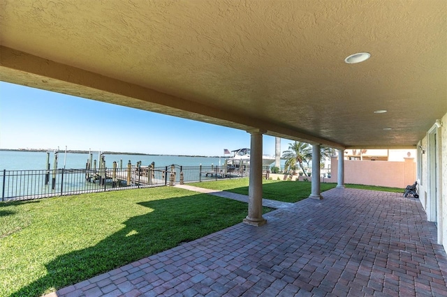 700 126th Ave, Treasure Island, FL 33706 - view of patio / terrace featuring a water view and fence
