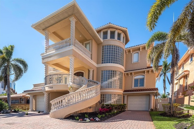700 126th Ave, Treasure Island, FL 33706 - view of building exterior with decorative driveway and a garage