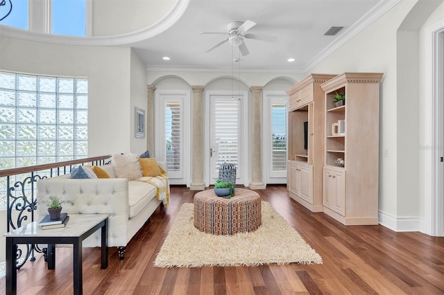 700 126th Ave, Treasure Island, FL 33706 - living room featuring dark wood-style floors, visible vents, crown molding, and a ceiling fan