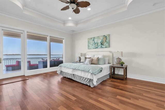 700 126th Ave, Treasure Island, FL 33706 - bedroom with a water view, ornamental molding, access to outside, wood finished floors, and a tray ceiling