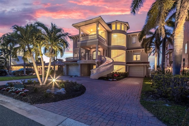 700 126th Ave, Treasure Island, FL 33706 - mediterranean / spanish-style house featuring a balcony, a tile roof, decorative driveway, and a garage