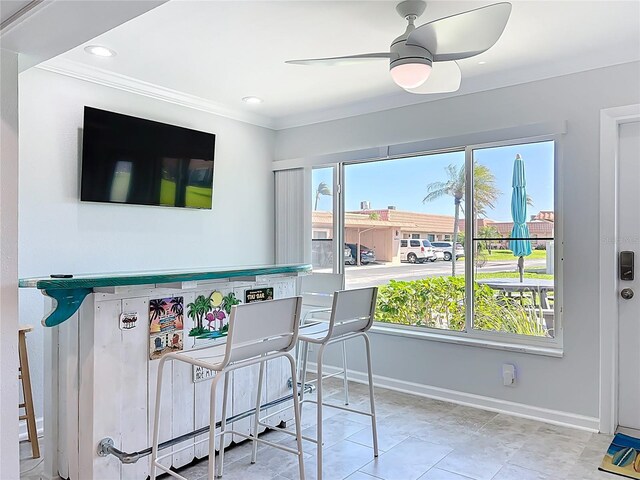 19029 US Highway 19 N Unit 27A, Clearwater, FL 33764 - dining area with healthy amount of natural light, baseboards, crown molding, ceiling fan, and tile patterned floors