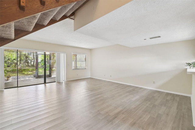 440 Woods Landing Trl, Oldsmar, FL 34677 - spare room featuring visible vents, a textured ceiling, baseboards, and wood finished floors