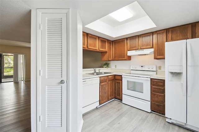 440 Woods Landing Trl, Oldsmar, FL 34677 - kitchen featuring light countertops, white appliances, under cabinet range hood, a sink, and light wood finished floors