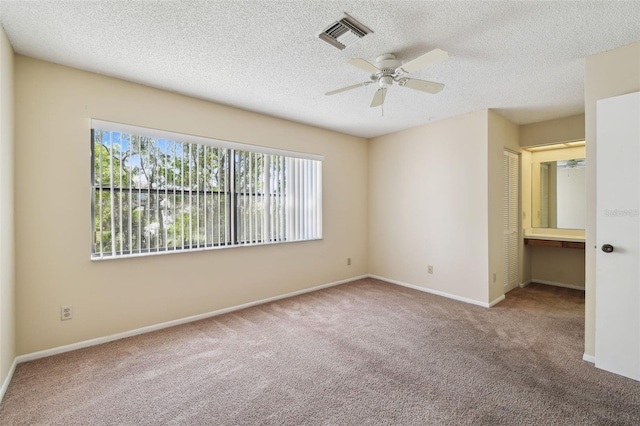 440 Woods Landing Trl, Oldsmar, FL 34677 - unfurnished bedroom featuring carpet, baseboards, a textured ceiling, and visible vents