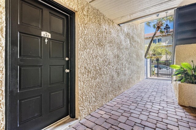 107 S Obrien St Unit 117, Tampa, FL 33609 - property entrance with stucco siding and a gate