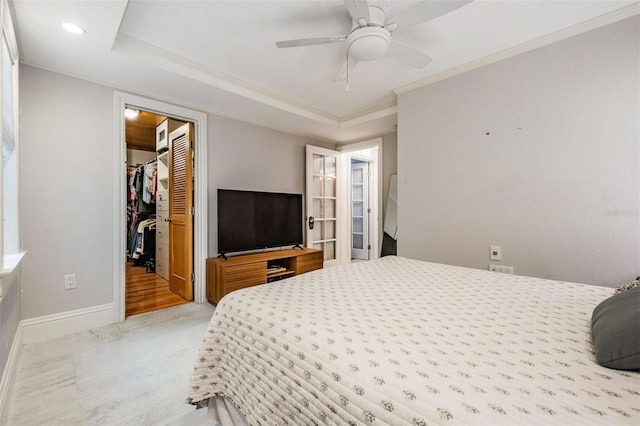 107 S Obrien St Unit 117, Tampa, FL 33609 - bedroom with a walk in closet, ornamental molding, a ceiling fan, a closet, and baseboards