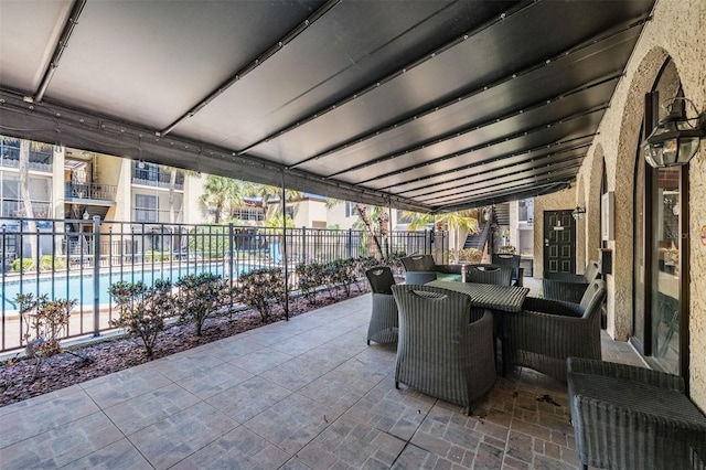 107 S Obrien St Unit 117, Tampa, FL 33609 - view of patio featuring outdoor dining space, a community pool, and fence