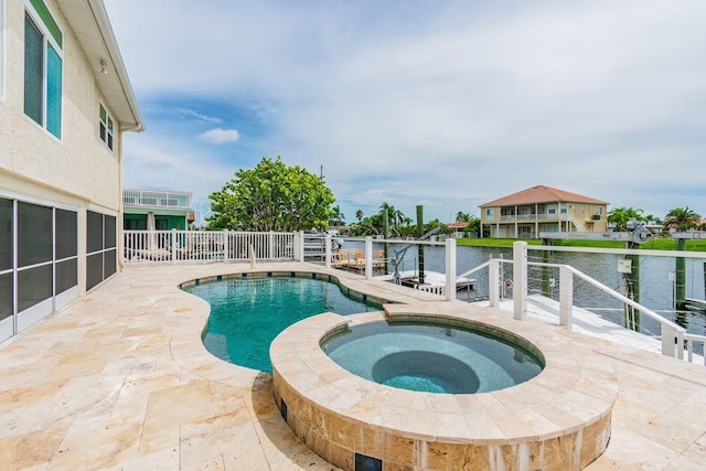 3545 Seaway Dr, New Port Richey, FL 34652 - view of pool featuring a patio area, a water view, and a pool with connected hot tub