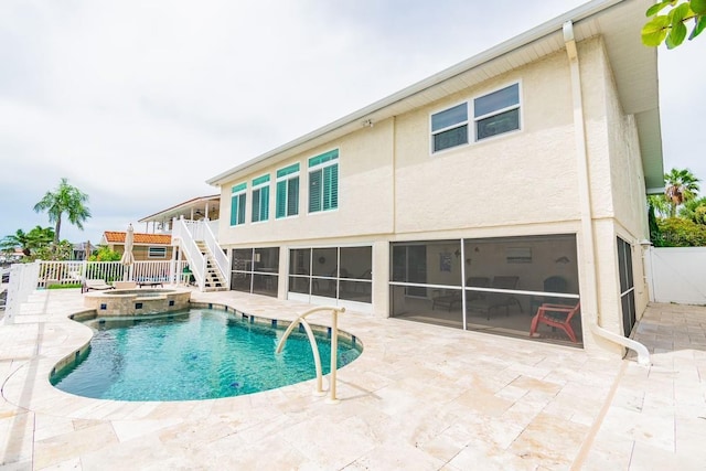 3545 Seaway Dr, New Port Richey, FL 34652 - view of swimming pool featuring stairway, fence, a pool with connected hot tub, a sunroom, and a patio area
