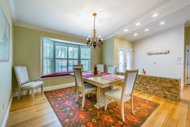 3545 Seaway Dr, New Port Richey, FL 34652 - dining space featuring a chandelier, french doors, crown molding, and light wood-style floors