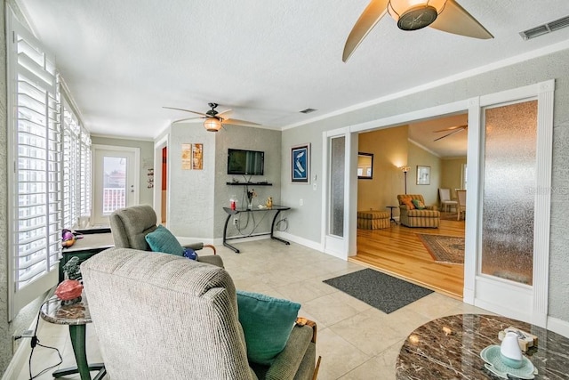 3545 Seaway Dr, New Port Richey, FL 34652 - tiled living area featuring a textured ceiling, crown molding, visible vents, and ceiling fan
