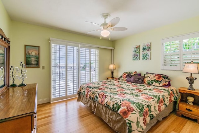 3545 Seaway Dr, New Port Richey, FL 34652 - bedroom with access to exterior, baseboards, light wood-type flooring, and ceiling fan