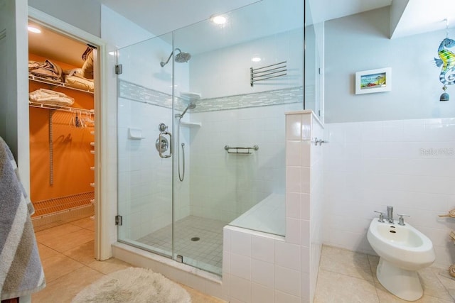 3545 Seaway Dr, New Port Richey, FL 34652 - full bath with tile patterned flooring, a spacious closet, a shower stall, a bidet, and tile walls