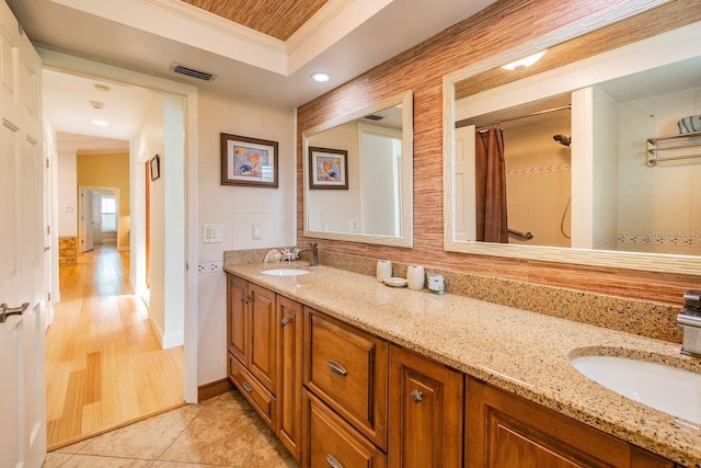 3545 Seaway Dr, New Port Richey, FL 34652 - full bath featuring double vanity, visible vents, crown molding, and a sink