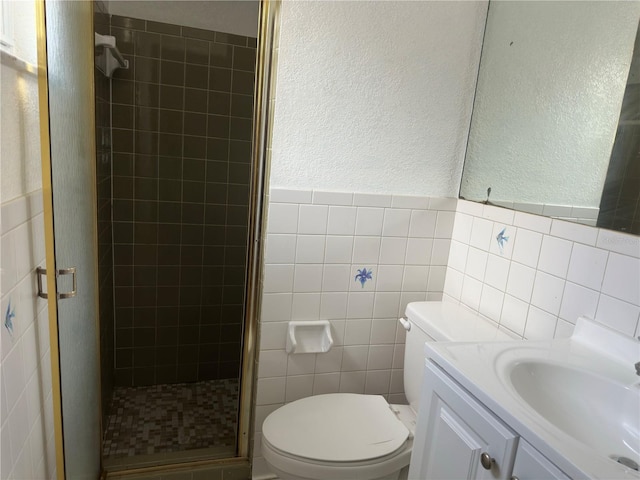 9741 Scenic Dr, Port Richey, FL 34668 - full bath featuring a shower stall, tile walls, toilet, vanity, and a textured wall