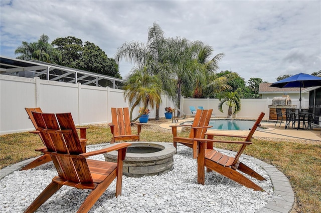 12299 91st Ave N, Seminole, FL 33772 - view of patio with a fenced backyard, a fenced in pool, and an outdoor fire pit