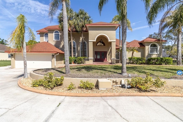 4404 Lake In The Woods Dr, Spring Hill, FL 34607 - mediterranean / spanish-style home with stucco siding, an attached garage, driveway, and a front yard