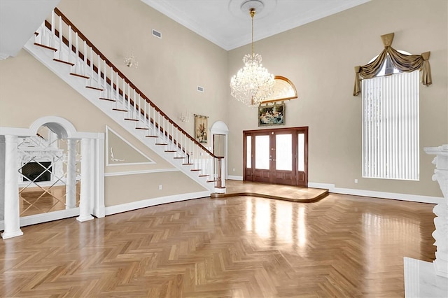 4404 Lake In The Woods Dr, Spring Hill, FL 34607 - foyer entrance featuring baseboards, stairway, a towering ceiling, a chandelier, and french doors
