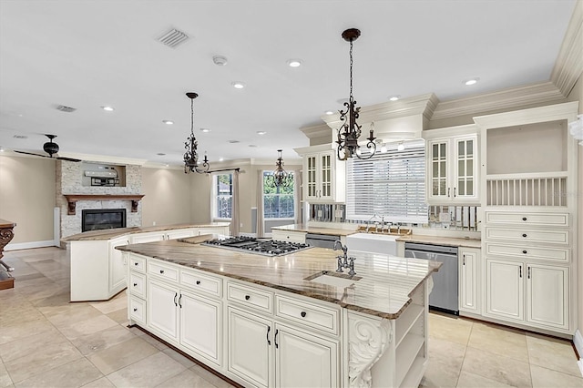 4404 Lake In The Woods Dr, Spring Hill, FL 34607 - kitchen featuring appliances with stainless steel finishes, a kitchen island with sink, open shelves, a chandelier, and a sink