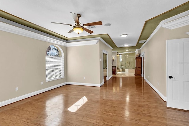 4404 Lake In The Woods Dr, Spring Hill, FL 34607 - spare room with crown molding, a ceiling fan, wood finished floors, and baseboards
