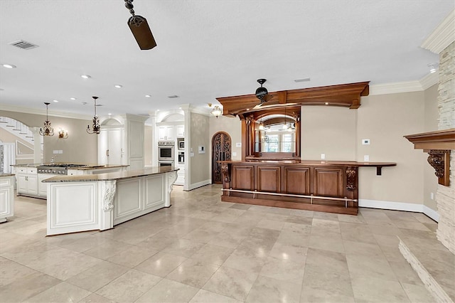 4404 Lake In The Woods Dr, Spring Hill, FL 34607 - kitchen with crown molding, appliances with stainless steel finishes, a spacious island, baseboards, and arched walkways