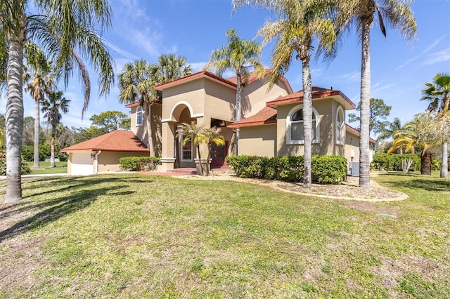 4404 Lake In The Woods Dr, Spring Hill, FL 34607 - mediterranean / spanish-style home with stucco siding, a garage, a front yard, and central AC