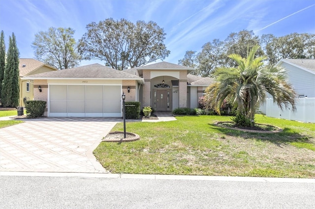 7472 Clearmeadow Dr, Spring Hill, FL 34606 - view of front of property featuring a front yard, fence, driveway, an attached garage, and brick siding