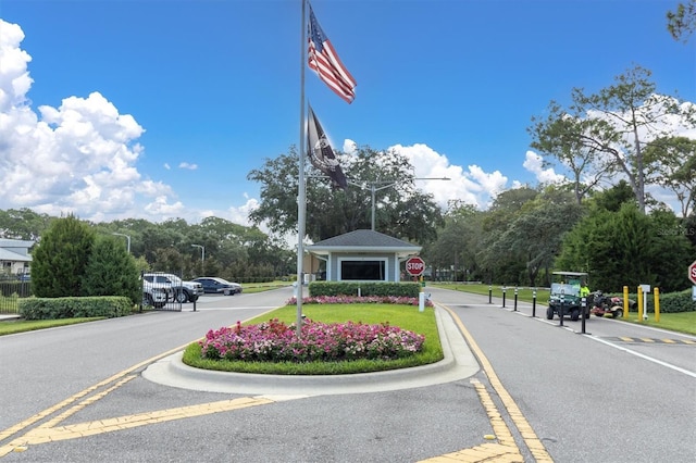 7472 Clearmeadow Dr, Spring Hill, FL 34606 - view of street featuring a gated entry, traffic signs, and street lights