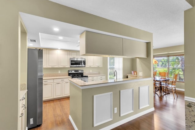 7472 Clearmeadow Dr, Spring Hill, FL 34606 - kitchen featuring visible vents, light countertops, recessed lighting, light wood-style flooring, and appliances with stainless steel finishes