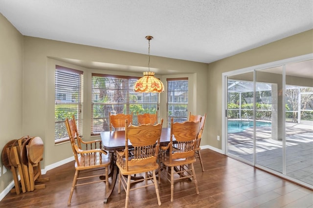 7472 Clearmeadow Dr, Spring Hill, FL 34606 - dining area featuring a healthy amount of sunlight, a textured ceiling, baseboards, and wood finished floors