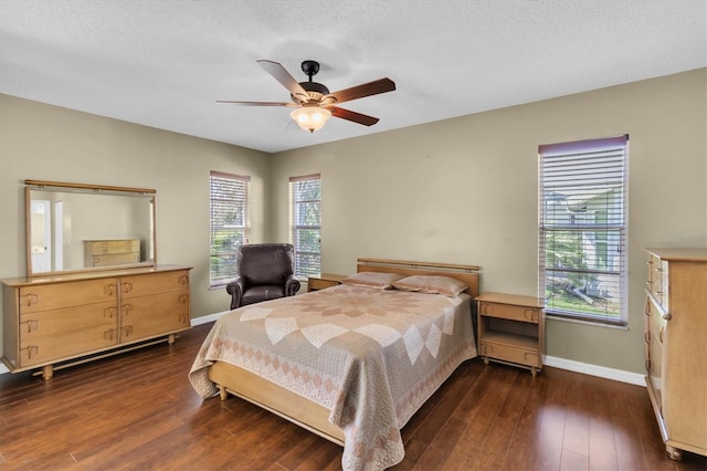 7472 Clearmeadow Dr, Spring Hill, FL 34606 - bedroom featuring baseboards, dark wood-type flooring, a ceiling fan, and a textured ceiling
