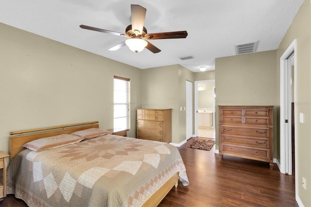 7472 Clearmeadow Dr, Spring Hill, FL 34606 - bedroom featuring visible vents, baseboards, connected bathroom, and dark wood-style flooring